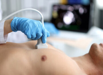 Doctor,Performs,Chest,Ultrasound,On,Man,In,Hospital,Closeup Doctor performs chest ultrasound on man in hospital closeup